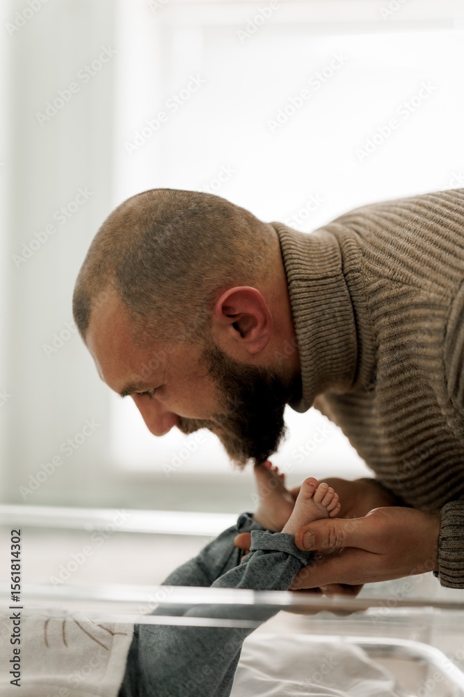 Obraz premium Tender Moment Between Father and Baby