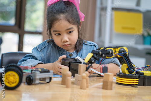 Girls learn and test robots they built in the classroom.