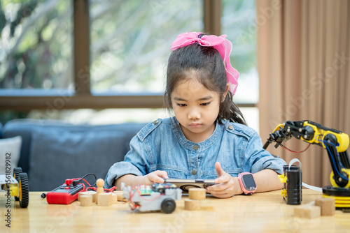 Girls learn and test robots they built in the classroom.