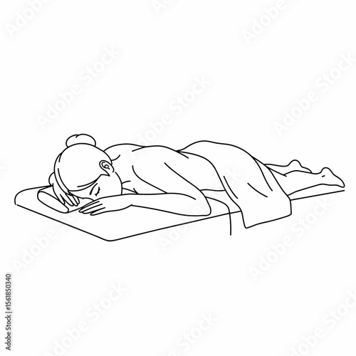 Woman receiving a massage while lying on a massage table  