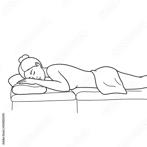 Woman relaxing on massage table with closed eyes in spa setting  