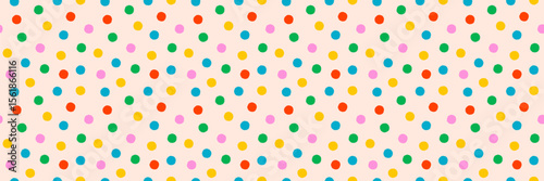 Colorful dot pattern on cream background. Seamless vector confetti texture fo...