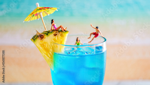 Trendy tiny people relaxing in blue summer cocktail with pineapple piece on the beach background copy space. Trendy creative bar menu. Cocktail drink blue lagoon with curacao liqueur and little people