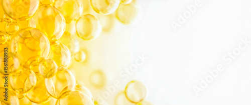 Hyaluronic acid skin solutions ad, collagen serum drops, vitamin C, oil. cosmetics advertising banner. Abstract oil bubbles background on light yellow background. Collagen Hydrolysate. Copy space