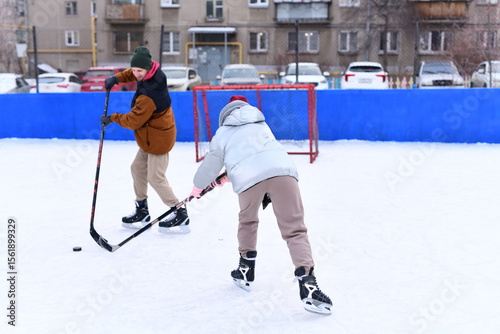 Photography People skate and play ice hockey in the yard