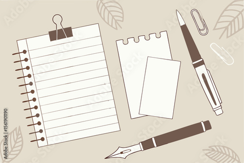Flat lay of writing instruments and paper with decorative leaves on a neutral background