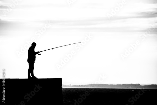 silhouette of a fisherman