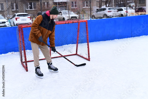 Photography People skate and play ice hockey in the yard