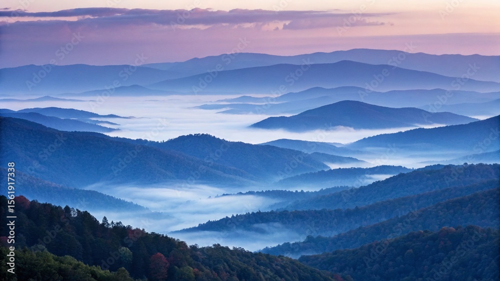 Obraz premium A panoramic view of misty mountains at sunrise reveals a serene and breathtaking landscape