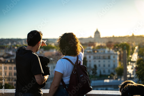 Couple observing the amazing warm view of Rome while sun goes down