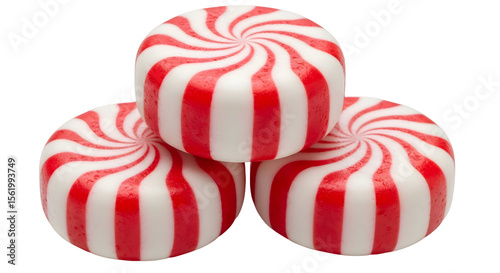 A close up of a stack of three peppermint candies with red and white stripes on a black background