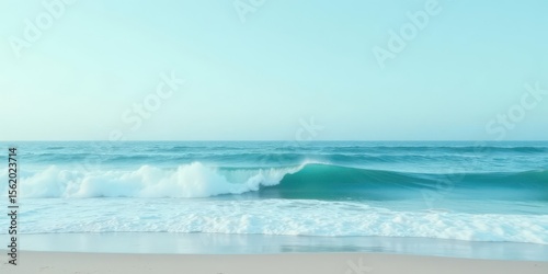 Serene Coastal Scene Gentle Waves Crashing on a Sandy Shore Under a Pale Sky