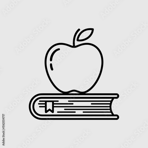 Apple resting on a book illustrating education and knowledge  