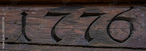 Historic 1776 Date Engraving on Aged Wooden Surface Symbolizing Legacy