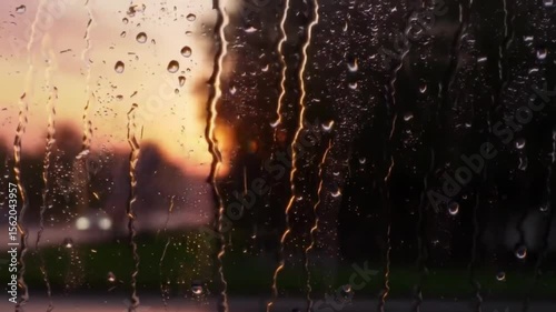 Raindrops on a window at sunset