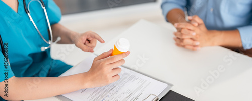 Canvastavla Doctor, female pharmacist holding a medicine bottle, gives advice, recommends how to take medicine to  patient