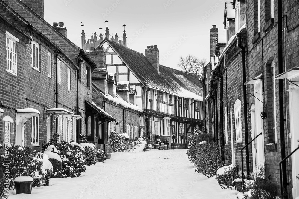 Fototapeta premium Snowy scene from England Alcester, Warwickshire, UK tudor buildings and old houses and streets in snow, black and white greyscale 7