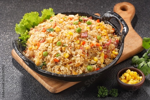 Nasi goreng Hongkong. Chinese Fried rice is a dish of cooked rice that has been stir-fried in a wok or a frying pan and is with other ingredients such as eggs, vegetables, seafood, or meat