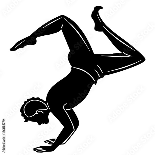 Silhouette of a man performing a handstand with legs extended in a graceful pose