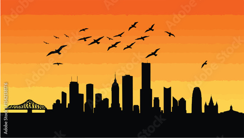 Silhouette of a city skyline at sunset with flying birds orange sky