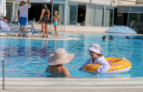 mother and daughter swimming in the pool