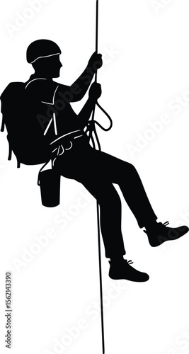 Silhouette of person rock climbing or rappelling with rope and backpack in mid-air

