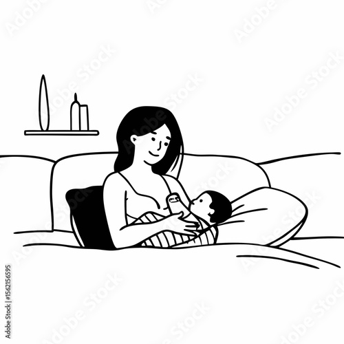 Mother lovingly breastfeeding her baby while sitting on a comfortable couch