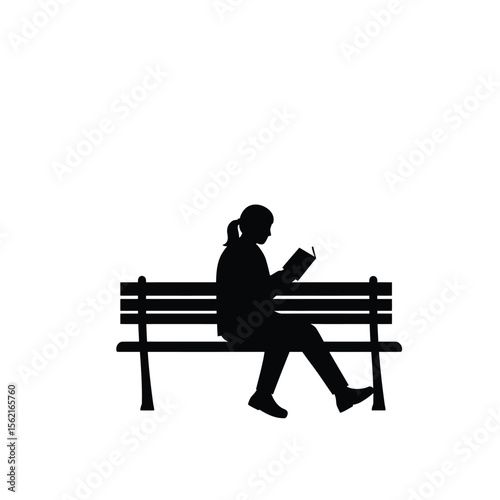 Silhouette of a  woman sitting on a bench with a book