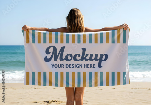 Blank Beach Towel Mockup Held by Woman on Sandy Shoreline with Ocean Background