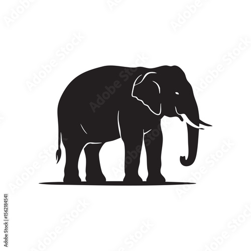 Majestic black elephant silhouette standing on a ground line isolated on white background