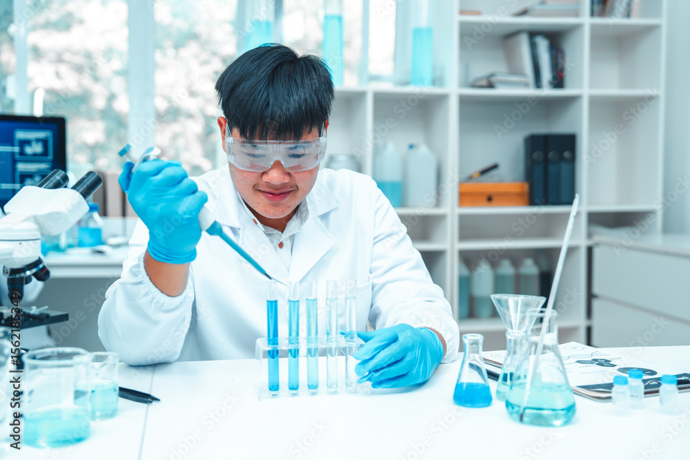 Fototapeta premium Scientist using micropipette for laboratory experiment in modern science lab. Concept of chemical research, liquid analysis, biotechnology, precision science, healthcare and diagnostics.
