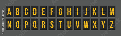 A full set of English alphabet letters are displayed on a rotating flip board. The letters are in yellow on a dark gray board against gray background.