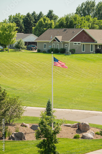 American flag flying in quiet suburban neighborhood