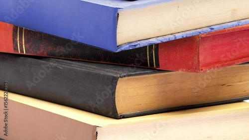 Stack of old books on wooden table closeup 4k video