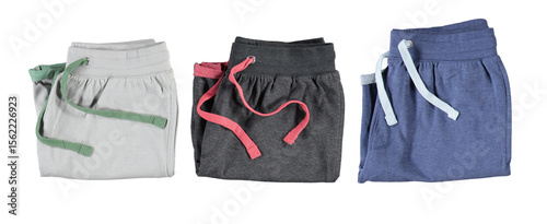 Folded grey and blue shorts with colourful laces. Isolated image on a white background. Nobody.