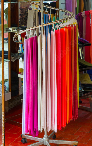 Colorful fashionable female scarves accessories hanging in a market outside