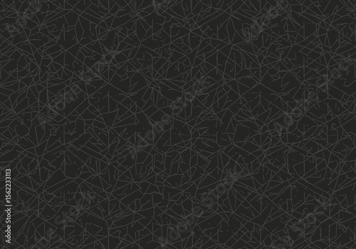 Dark gray abstract surface with jagged scattered lines creating a textured pattern