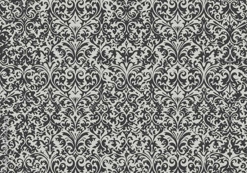 Detailed ornate pattern in black and white with floral and scroll elements