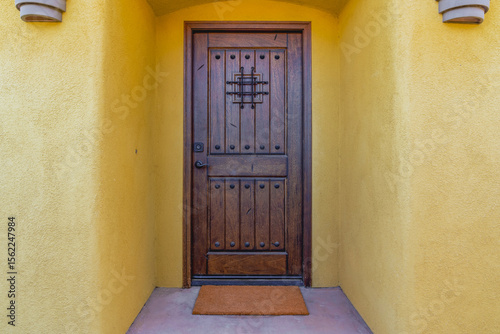 Rustic Mediterranean Tuscan style wood door on a Southwest adobe home.
