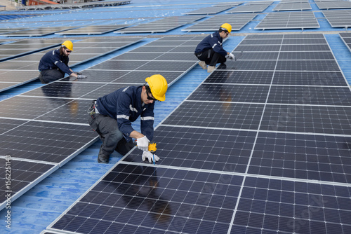 Engineer repair solar panel on the factory rooftop