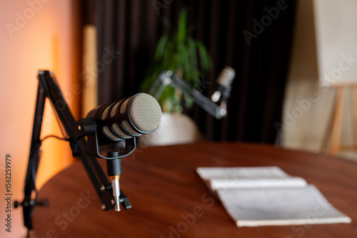 Schilderij op canvas Detailed setup of a podcast recording space featuring microphones and an invitin