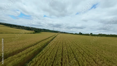Wallpaper Mural Aerial FPV drone flight around electricity pylon crops harvest field 360 degree spin rural England UK Torontodigital.ca