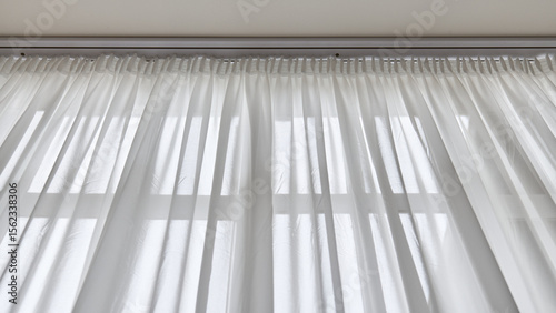 Light through sheer white curtains in a bright room