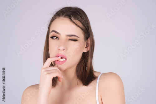 Blinking eye concept. Sensual girl winking eye on isolated background. Young woman blinking with expression. Fun blinking face. Portrait of pretty girl blinking.