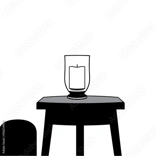 A glass candle holder on a side table