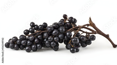 Photograph of a dark cluster of grapes resting on a white background.