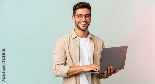 Man Smiling Holding Laptop Computer in Studio