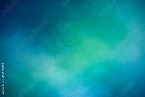 Abstract soft focus background with a gradient of deep blue and vibrant teal green colors creating a dreamy ethereal atmosphere