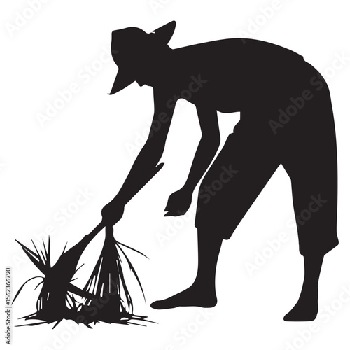 Silhouette of a farmer wearing a hat gathering crops with a bundle