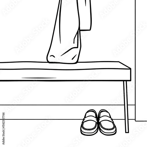 A pair of loafers under a hall bench